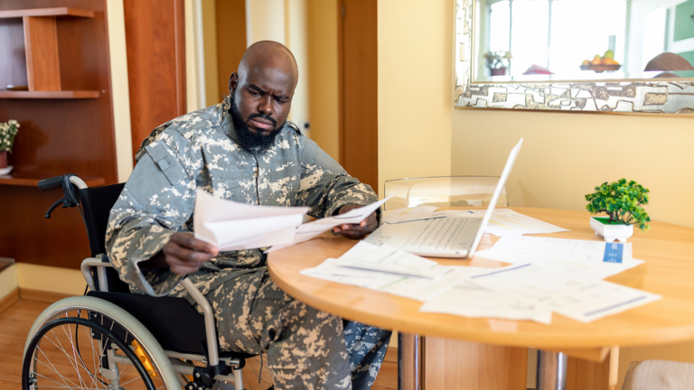 veteran in front of computer and documents
